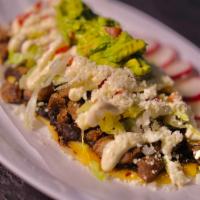 Huarache · Handmade Tortilla Stuffed with Beans Topped With Meat,Lettuce,& Tomatos Drizzled with Sour C...