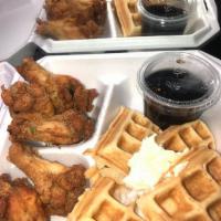 Chicken and Waffles · 4 fried chicken wings with a large Belgian waffle topped with powdered sugar. Served with wa...