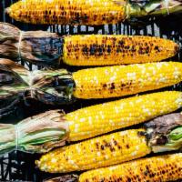 1 Piece Grilled Elotes · Grilled fresh corn on the cob with cojita cheese, parsley, cilantro, lime and chili spice.