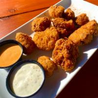 Cauliflower Bites · Panko-breaded and deep fried cauliflower tossed in dragon dust and served with a dipping sau...