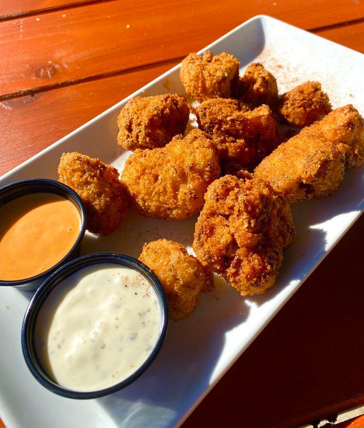 Cauliflower Bites · Panko-breaded and deep fried cauliflower tossed in dragon dust and served with a dipping sauce of your choice.