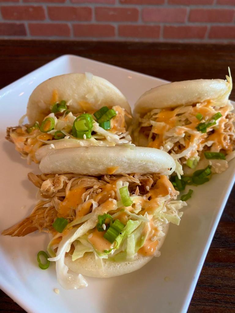 Shoyu Bao Special · Shoyu chicken bao buns with a sesame dressing slaw, pickled cucumbers, green onions, and spicy mayo on top.