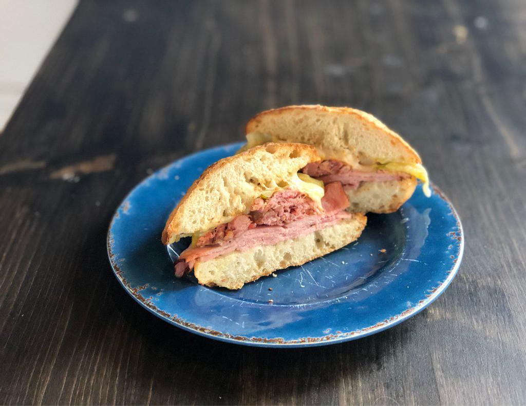 Cuban Sandwich  · Classic Cuban: fresh ham, Swiss cheese, mustard and pickles. Served nice and toasty!