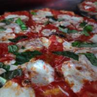 Margherita Pizza · Pizza sauce, fresh mozzarella and basil, topped with Romano.