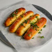 Garlic Breadsticks · Fresh-baked pizza bread topped with melted butter, garlic and parsley, served with marinara ...
