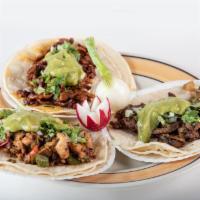 Taco de Bistec · Grilled steak. Todos servidos con cebolla, cilantro, guacamole, rabano y cebollinas. All com...