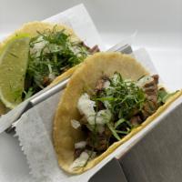 Taco de Carne Asada · Two 48hr marinated grilled flank steak tacos, diced yellow onion & fresh cilantro. Served wi...