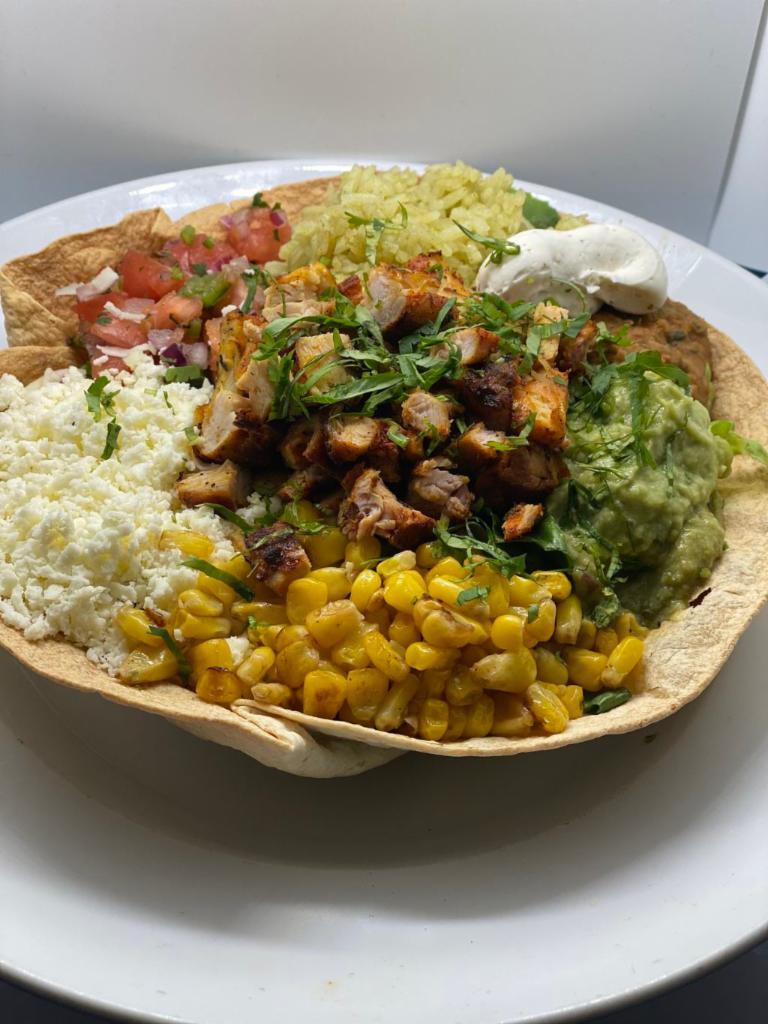 Pollo Asado Bowl · Romaine lettuce, pico de gallo, guacamole, queso fresco, corn, cilantro, jalapeno, tomates. Served in a
deep fried tortilla bowl. 