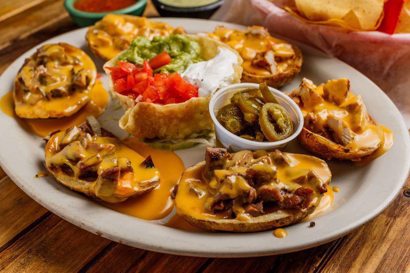 PAPA Nachos 1/2 Order · Potato skins topped with chile con queso, guacamole, sour cream
and jalapenos. Grilled chicken or beef fajita