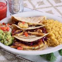 Fish Taco · Two homemade flour tortillas stuffed with cabbage and grilled
tilapia. Served with rice, ch...