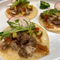 Adobo Pork Belly Quesa Taco · Slow-cooked adobo pork belly with pan seared to a crisp Monterey Jack cheese and corn tortil...