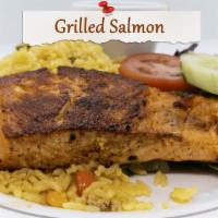 Grilled Salmon · Grilled and topped with our seafood sauce, served with rice and salad or rice and beans.