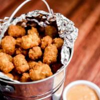 Bucket of Tots · Large bucket of tater tots with our secret plant-based tot sauce on the side. Vegan. Gluten-...