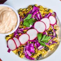 Street Style Scramble Bowl · Roasted corn, black beans, purple cabbage, sliced radish, and salsa verde topped with plant-...