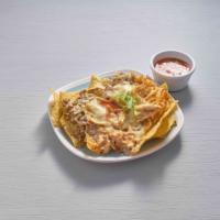 Nachos Supreme · Nachos with melted cheese, ground beef, pulled chicken, refried or black beans, topped with ...