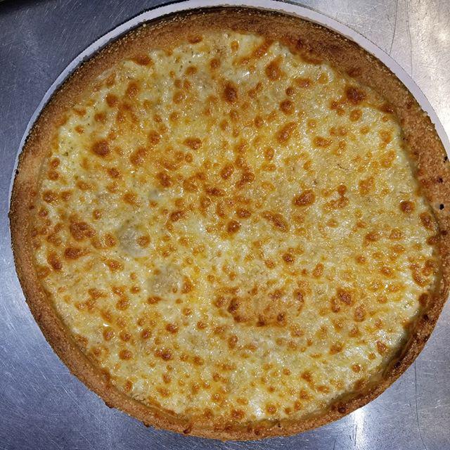 White Roman Pizza · Parmesan, fresh garlic, virgin olive oil, and mozzarella with no sauce. Made fresh daily dough and house cut mozzarella and white cheddar cheese.
