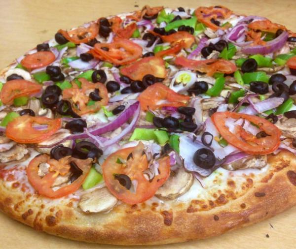Vegetarian Pizza · Marinated artichoke hearts, fresh mushrooms, sun-dried tomatoes, red onions, bell peppers and tomatoes and topped with feta cheese. Vegetarian.