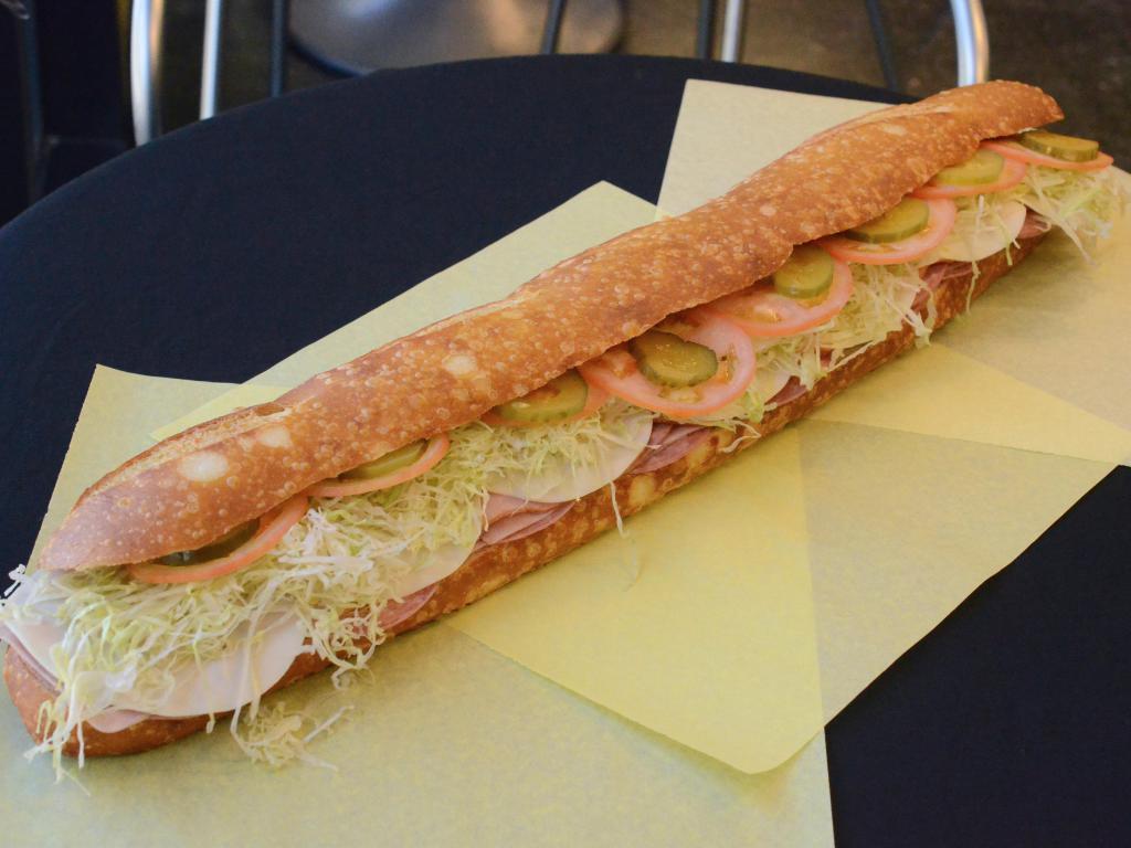 Italian Combo Sandwich · Dry salami, ham, cotto salami, pressed ham and cheese. Mustard, mayo, lettuce, tomatoes, pickles, and onions. 
