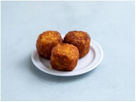 Mega Tots · Three jumbo tater tots stuffed with Cheddar cheese and fried to golden perfection. Handmade daily!