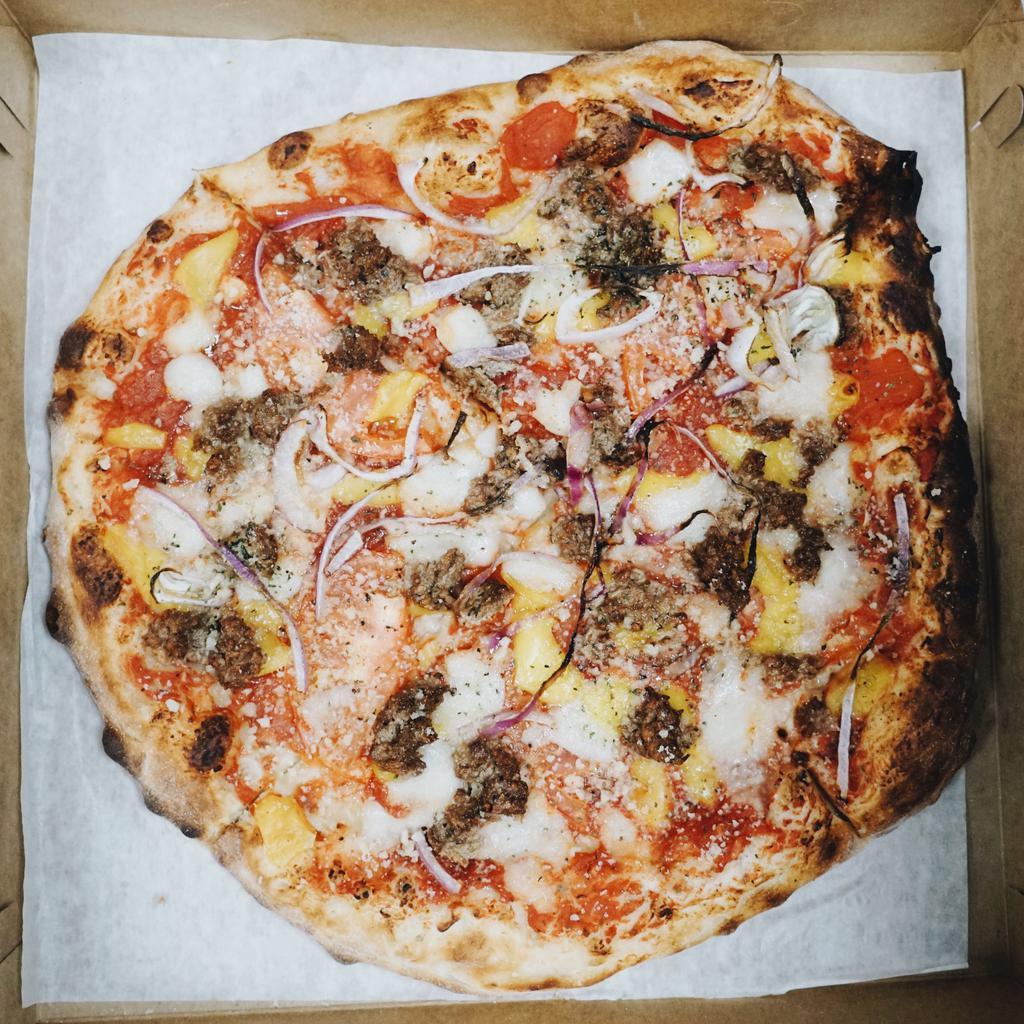 Cheeseburger Pizza · VEGAN.
--
Impossible burger, fresh tomato,  cheddar, parmesan, organic mozzarisella, red onion, marinara, wheat crust.
--
For Gluten-free crust options, GF pizzas are baked in proximity to wheat flour and may not be suitable for severe allergies.