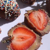 Chocolate covered strawberry bonbon · A handpicked strawberry filled with white chocolate brigadeiro inside and covered with milk ...