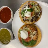 Tostadas · Choice of meat. Comes with beans, cheese, lettuce, tomatoes, and sour cream.

