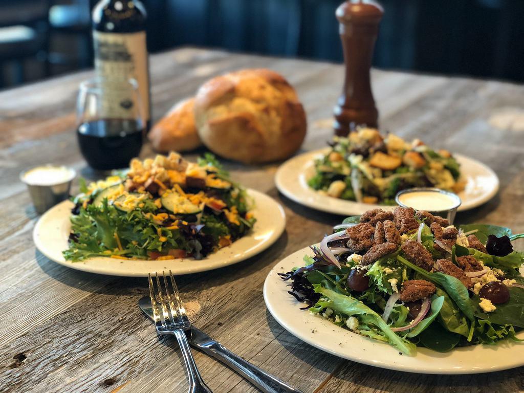 Summer Bleu Salad · Spinach and Arcadian mix, candied pecans, red grapes, red onions, blue cheese crumbles and our house made blue cheese dressing.