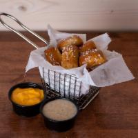 Pretzel Bites · 10 warm pretzel bites served with melted cheddar and honey mustard sauce.