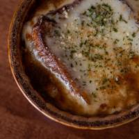 Baked French Onion Soup · A bowl of our homemade onion soup topped with a large homemade crouton and melted mozzarella...