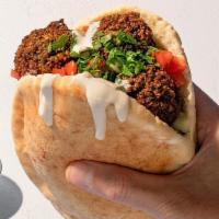 In A Pita Classic Falafel  · Our Award Winning fresh baked pita filled with chickpea zucchini falafel, traditional hummus...