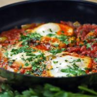 Traditional Shakshuka · 2 eggs poached in delicious tomato sauce, peppers, onions & garlic, pleasantly spiced with c...