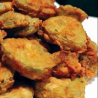 Fried Pickles · Pickles chips battered and fried crispy with a savory flavor. Ranch to dip on the side.