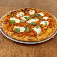 Regina Margherita  · Fresh mozzarella cheese over pizza sauce cooked to perfection and topped with fresh basil le...