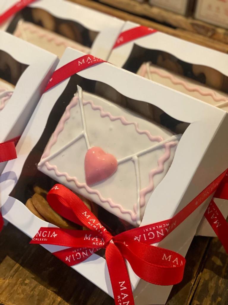 Valentine's Day Cookie Box (12pc) · One large hand decorated cookie & 11 heart shaped linzer cookies
