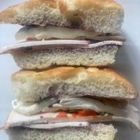 Oven Roasted Chicken Hot Sandwich · fresh mozzarella, roasted peppers, basil, black olive tapenade, on focaccia bread