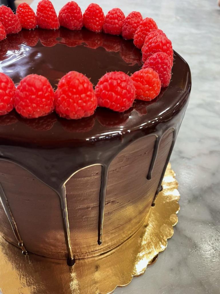 Raspberry Chocolate Cake · 24 HR NOTICE REQUIRED. Moist chocolate sponge cake layered alternately with raspberry filling and chocolate mousse with fresh raspberries.