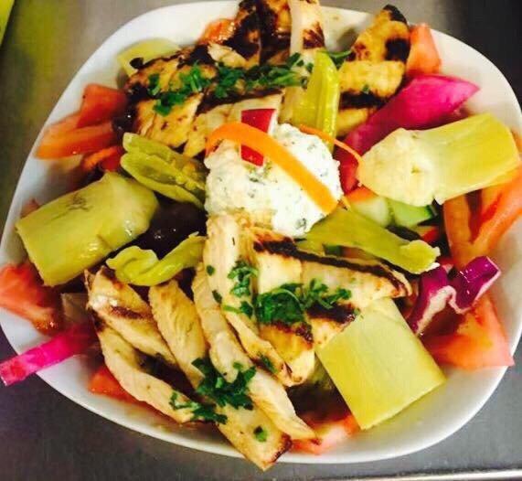 Greek Salad · Fresh vegetables, feta cheese, stuffed grape leaves and artichokes.