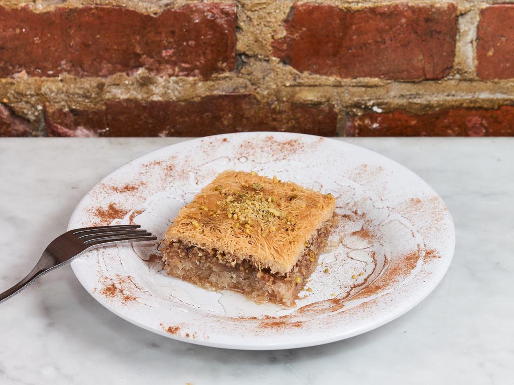 Kataifi · Sweet pastry made of extremely thin shredded dough layered with chopped nuts and honey syrup baked with butter.
