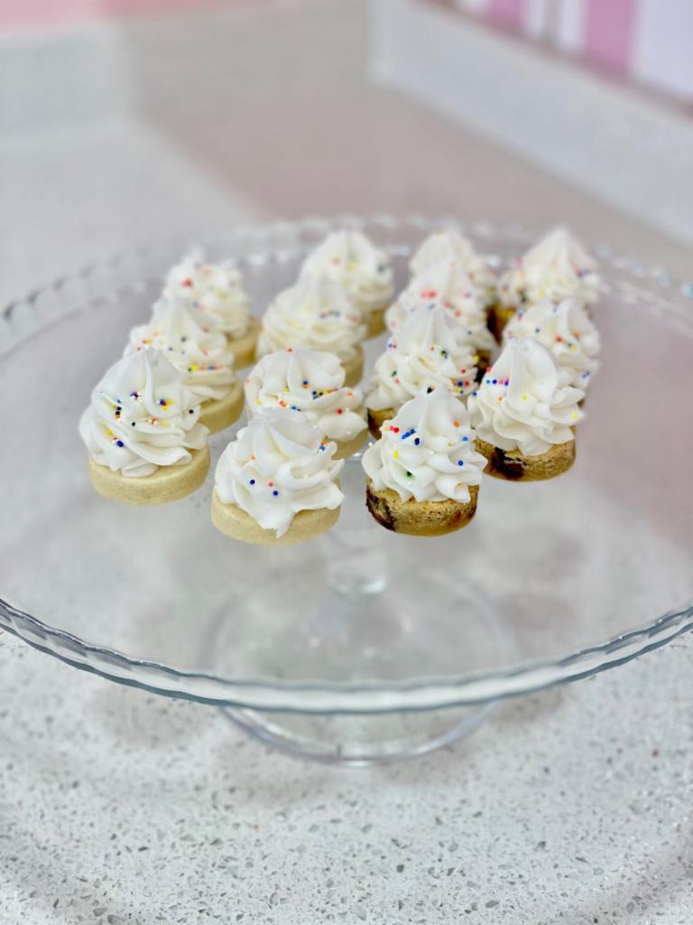 Buttercream Bites · Bite size sugar cookies and cookie cake topped with Buttercream Icing and sprinkles! Yum!