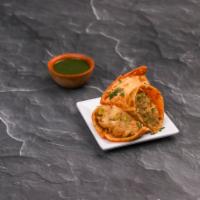 Samosa · 2 pieces. Crispy puff pastry stuffed with lightly seasoned potatoes and green peas. Served h...