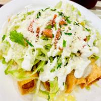 Tacos Dorados (4) in the order  · (4) Crispy rolled tacos topped with: beans, lettuce, tomato, sour cream,  cheese and cilantr...