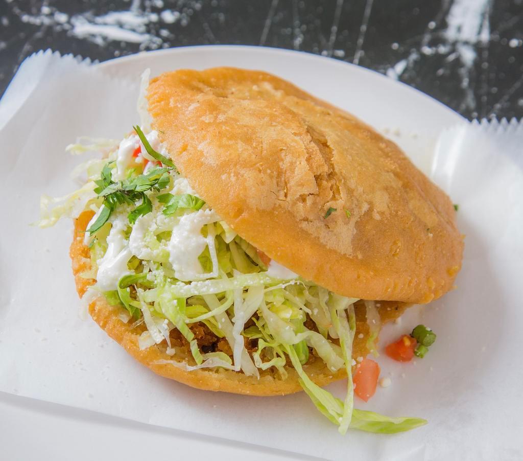 Gorditas · Homemade corn dough fried and topped with: lettuce, tomato, sour cream, cheese and cilantro. Choice of filling 