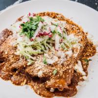 Enchiladas de Mole · (4) Rolled tortillas topped with homemade mole sauce, lettuce, cotija cheese, onions, and ra...