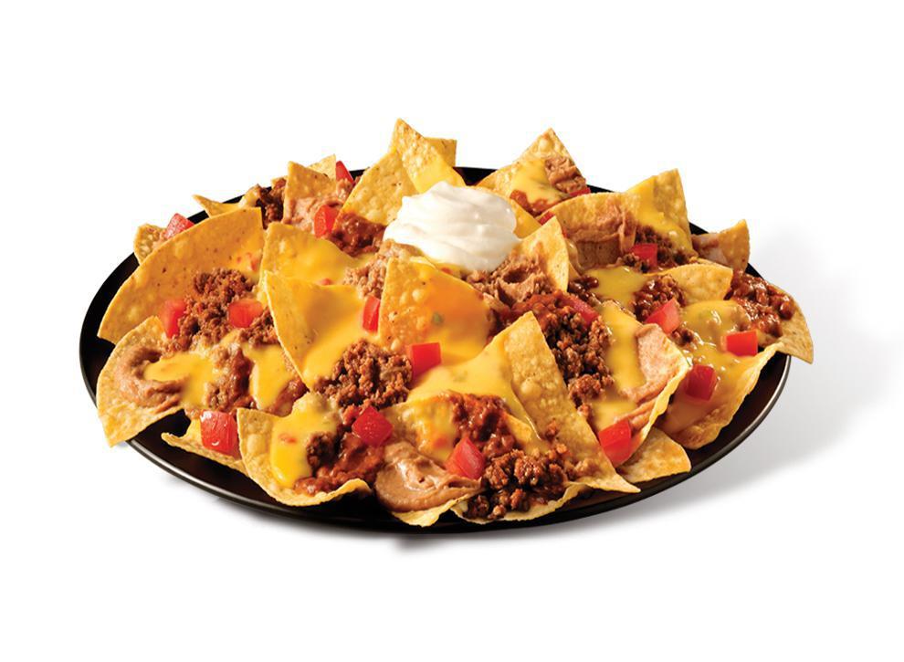 Big Freak’n Nachos Beef · The Big Freak’n Nachos are for when your eyes are bigger than your stomach, loads of queso, beef, beans, chili, and more cheese. Topped with sour cream, guac, jalapenos and tomatoes, it has all of the indulgences you crave.