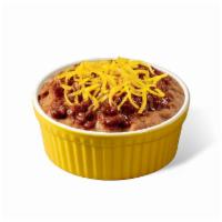 Party Beans · This warm side features slow-simmered refried beans, spicy chili sauce and shredded cheddar ...