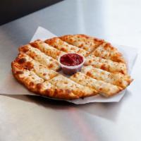 Cheesesticks · Fresh dough brushed with garlic and olive oil or pesto sauce and topped with mozzarella chee...