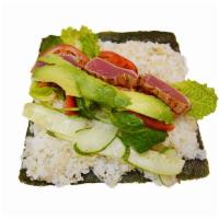 Seared Yellow Fin Tuna Burrito* · Seaweed, rice, lettuce, avocado, spinach, tomato, cucumber, sauce. *=Raw. Real photo