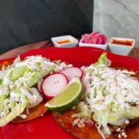 Enchiladas · Corn tortillas in deep homemade sauce with shredded chicken, lettuce, fresh cheese, onions, ...