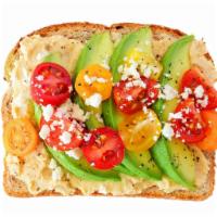 Avocado Hummus Toast · Multigrain toast, hummus, avocado, cracked black pepper, sea salt, and vine tomatoes.
