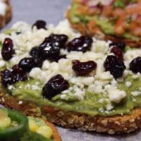 Cranberry Avocado Toast · Multigrain toast, avocado spread, feta, and dried cranberries drizzled with honey.
